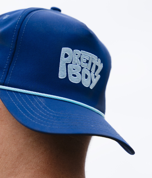 Blue hat with "Pretty Boy" in white letters and white rope on brim