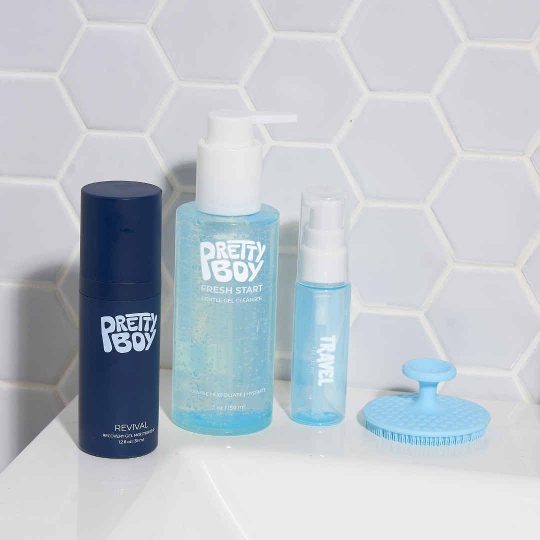 Skin start kit bottles and exfoliating brush on bathroom counter