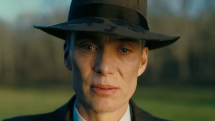 Close-up of a person wearing a dark hat outdoors with a blurred background