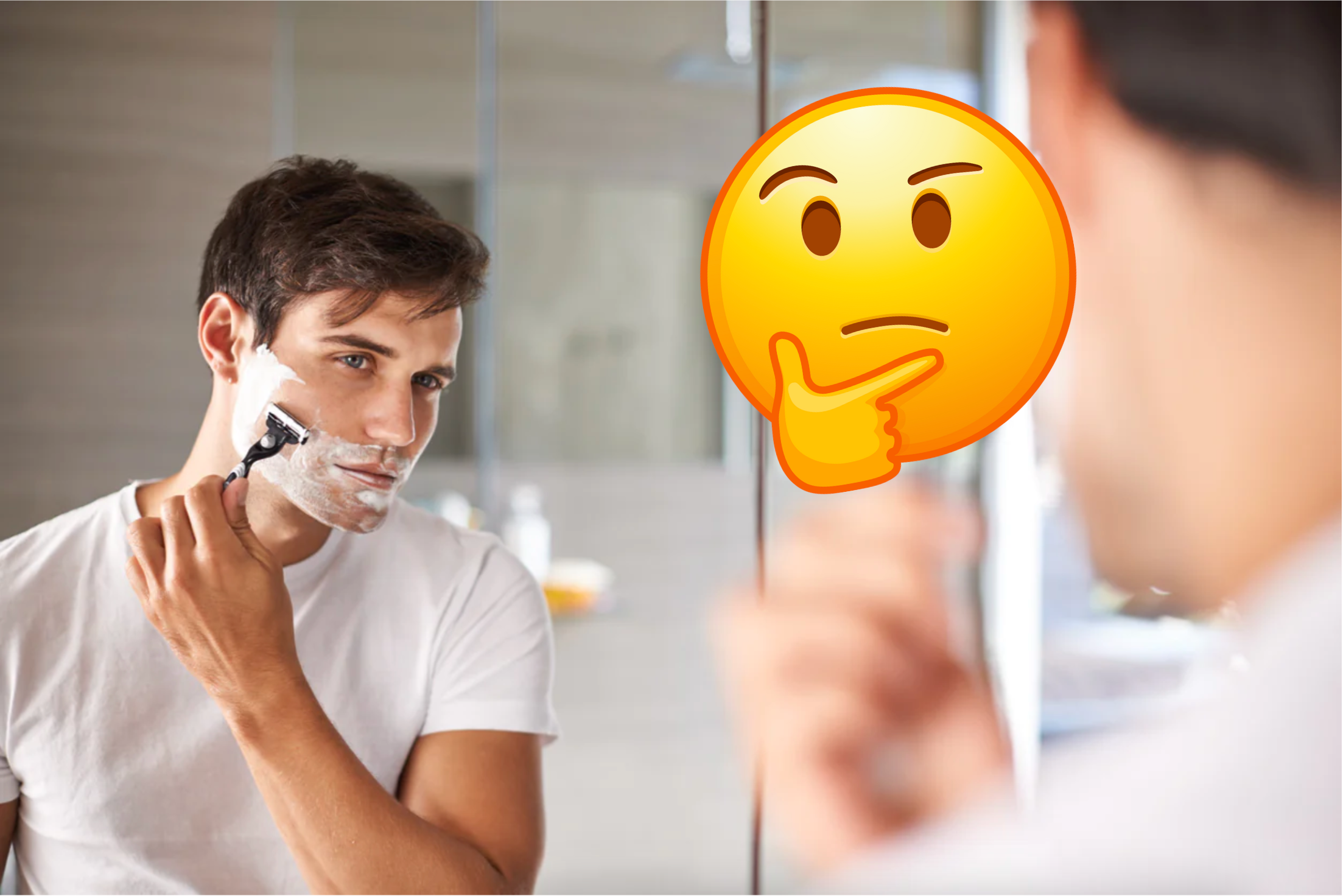 Man shaving his face in front of a bathroom mirror
