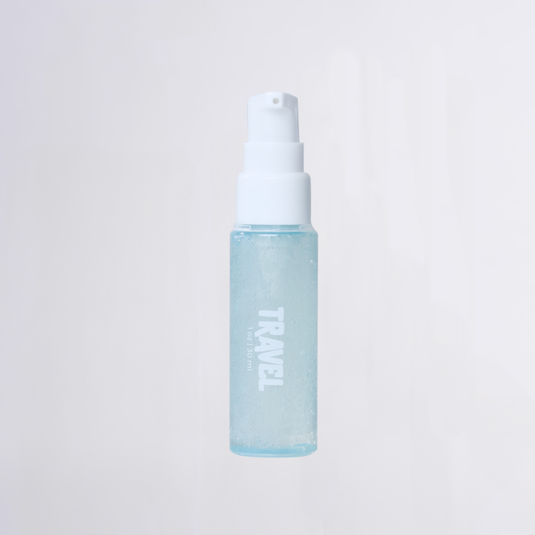 Clear travel-size pump bottle with blue gel, labeled TRAVEL and 1 oz | 30 ml